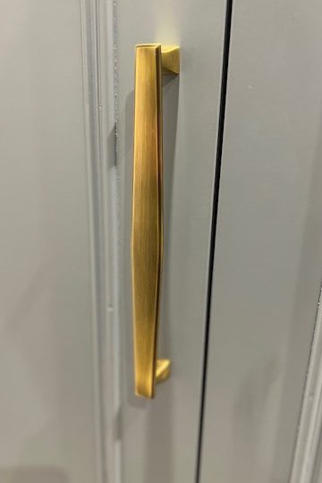 Brushed brass wardrobe handle on shaker door with smooth spray painted finish